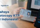 Ilustrasi seseorang memegang KTP di depan laptop dan smartphone dengan ikon gembok keamanan, menggambarkan risiko fotocopy KTP dan pentingnya identitas digital.
