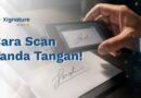 Seseorang menggunakan kamera smartphone untuk memindai atau mengambil gambar tanda tangan basah di atas kertas dokumen.