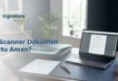 Scanner flatbed memindai kontrak bertanda tangan dengan laptop menampilkan hasil PDF.